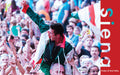 Contrada supporter lifted on shoulders, fist raised in triumph at the Palio di Siena